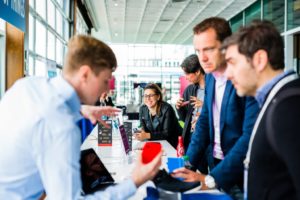 Attendees talking to a vendor table top