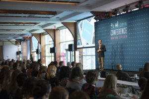 Conference and speaker on stage, audience listening
