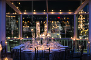 Candles lit on fancy table with plates and cutlery