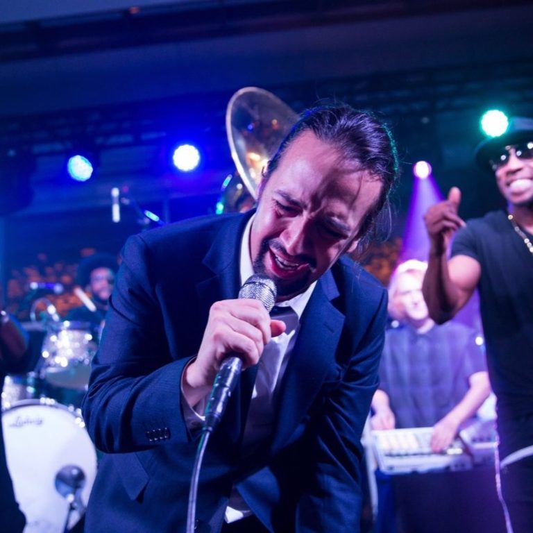 Lin Manuel Miranda performing on stage at Pier Sixty