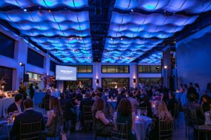 Current in Blue LED ceiling lights with guests seated at tables
