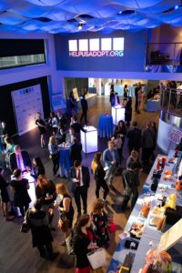 Current in Blue ceiling LED Lights, guests standing during cocktail hour