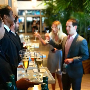 Man and woman served drinks by waitstaff