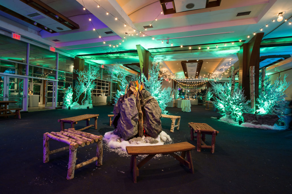 Benches around fake rocks and fire in winter scene