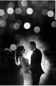 Bride and Groom outside of the Lighthouse standing facing each other holding hands