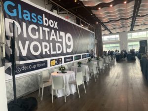 Current set with cocktail tables and branding on the wall