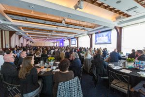 presenters on stage at a meeting at Pier Sixty