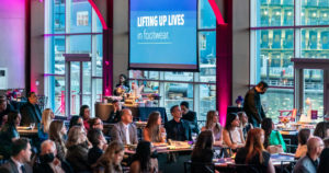 Guests seated at Pier Sixty, listening to the speaker
