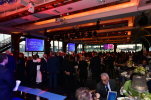 Guests enjoying dinner at the floor to ceiling windowd Ballroom for the Mount Sinai Crystal Party at Pier Sixty
