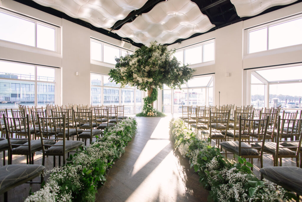 Wedding Ceremony at Current. center aisle and a beautiful custom tree as the foal front point for the bride and groom to stand under.