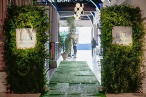 The Lighthouse entrance decorated in green with fresh plants and green walls and capet