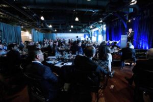 Forbes Meeting at The Lighthouse, speaker on stage addressing the audience in the venue.