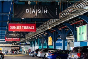 View of Pier 61 parking lot with Dash banners and posters leading up to venue